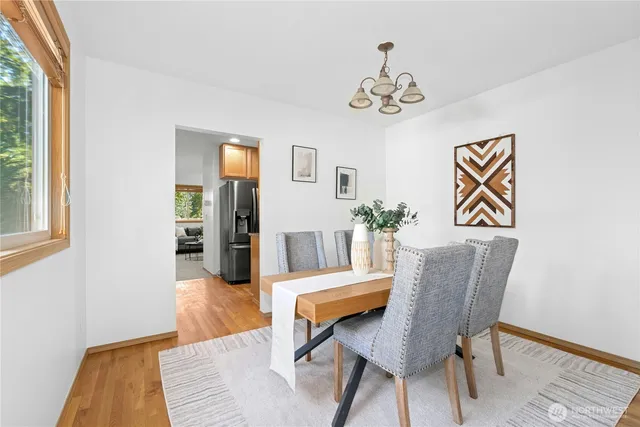 a view of a dining room with furniture and wooden floor