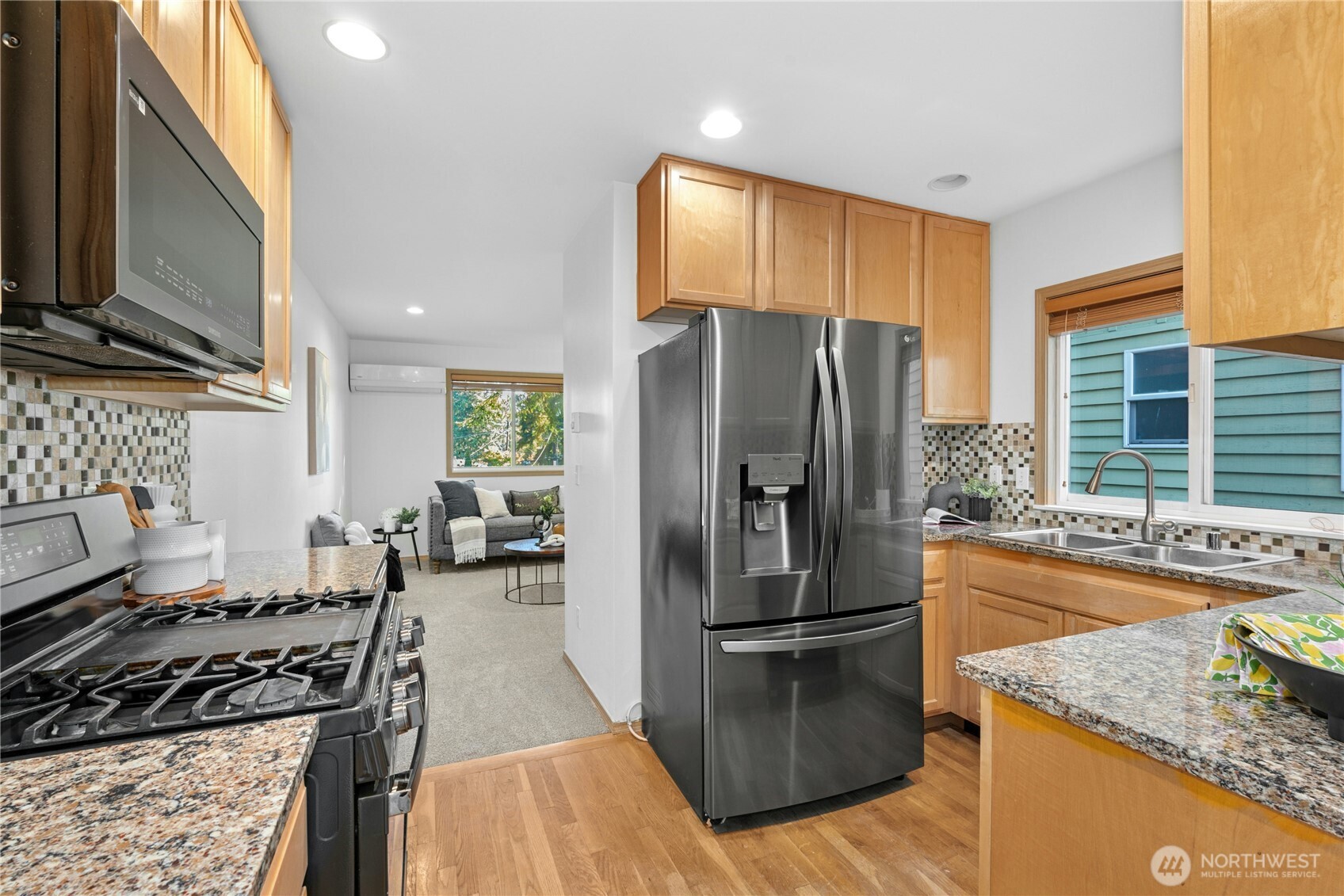 14348 Wallingford Avenue North Seattle, WA 98133 - Photo 7 of 28 a kitchen with granite countertop a refrigerator stove and sink
