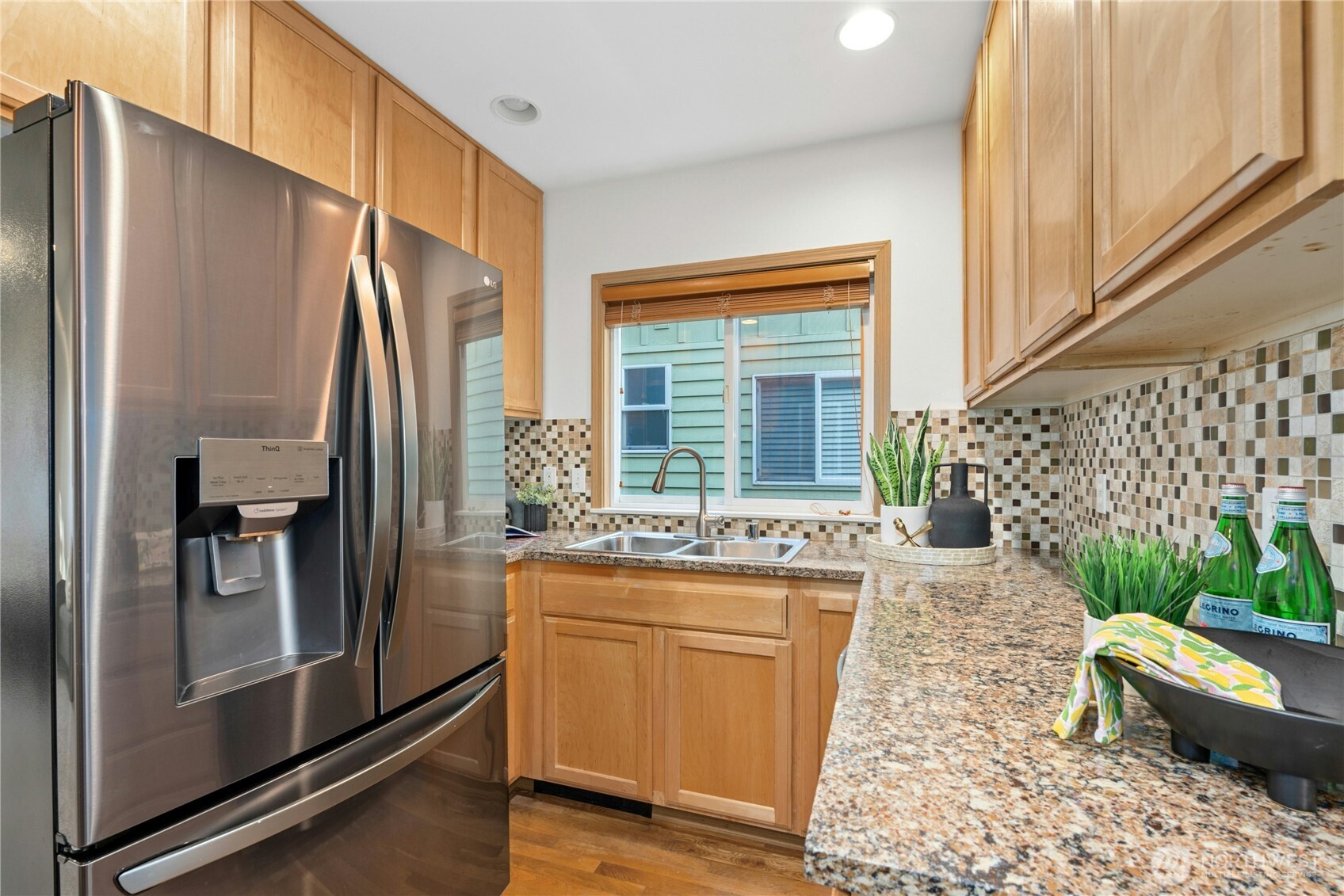 14348 Wallingford Avenue North Seattle, WA 98133 - Photo 9 of 28 a kitchen with stainless steel appliances a refrigerator and a stove