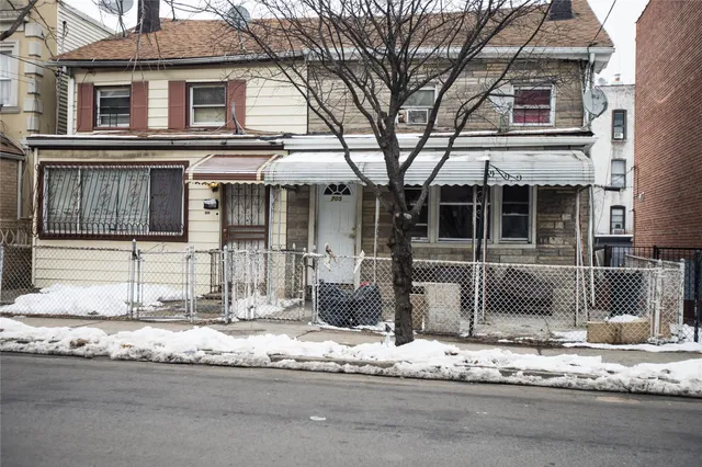 a front view of a house with lots of windows