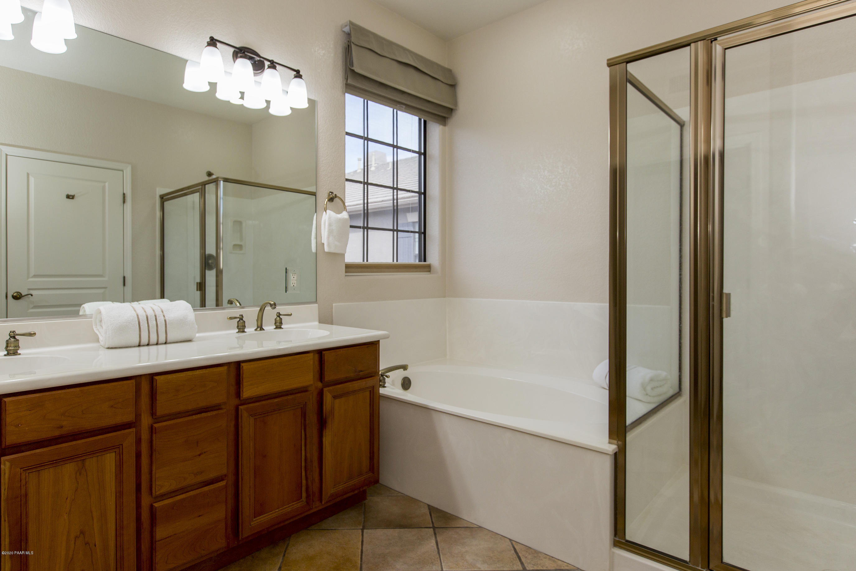 1716 Alpine Meadows Lane, Unit 403 Prescott, AZ 86303 - Photo 17 of 39 a bathroom with a tub sink and mirror