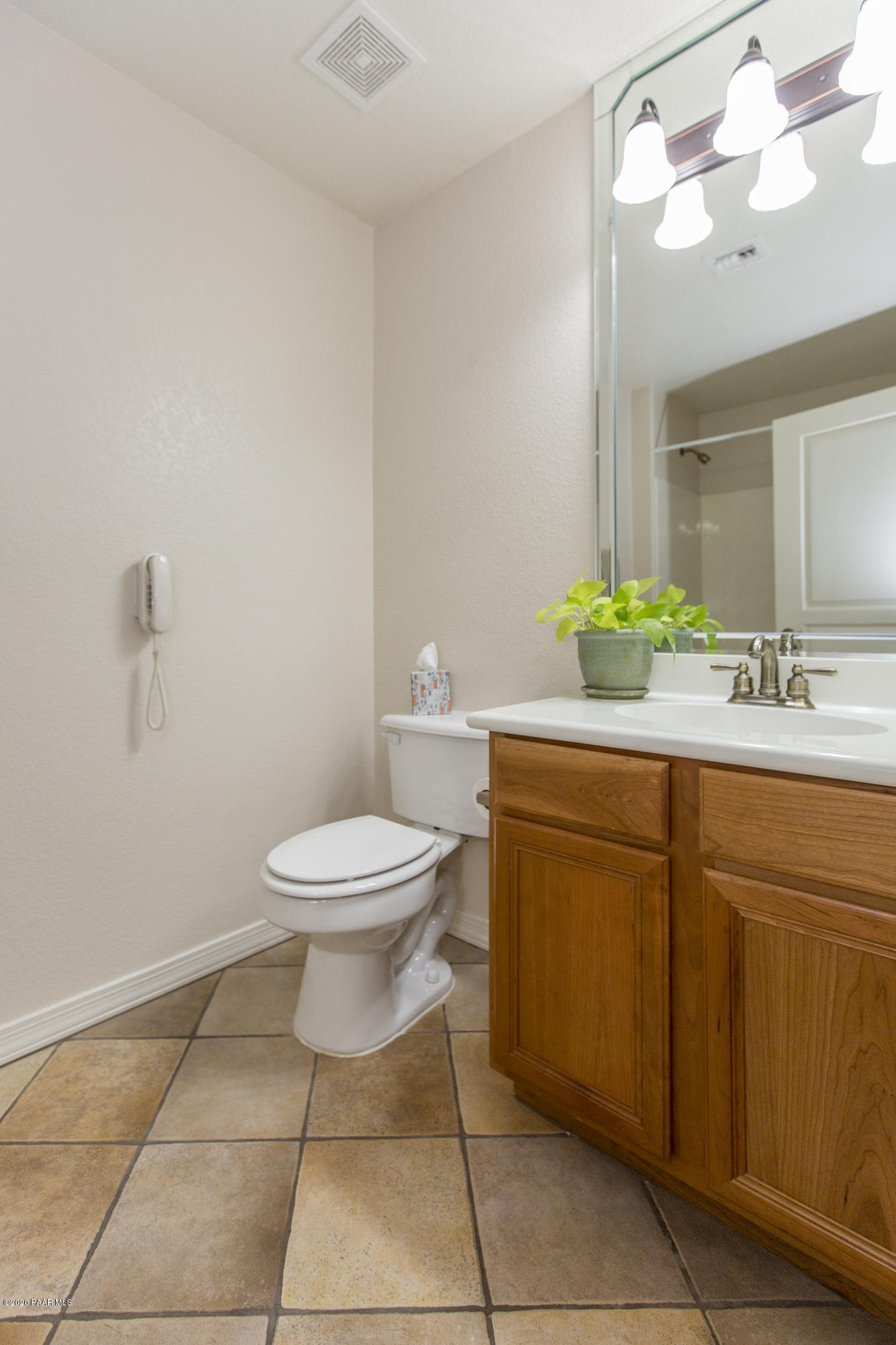 1716 Alpine Meadows Lane, Unit 403 Prescott, AZ 86303 - Photo 23 of 39 a bathroom with a granite countertop toilet sink and mirror