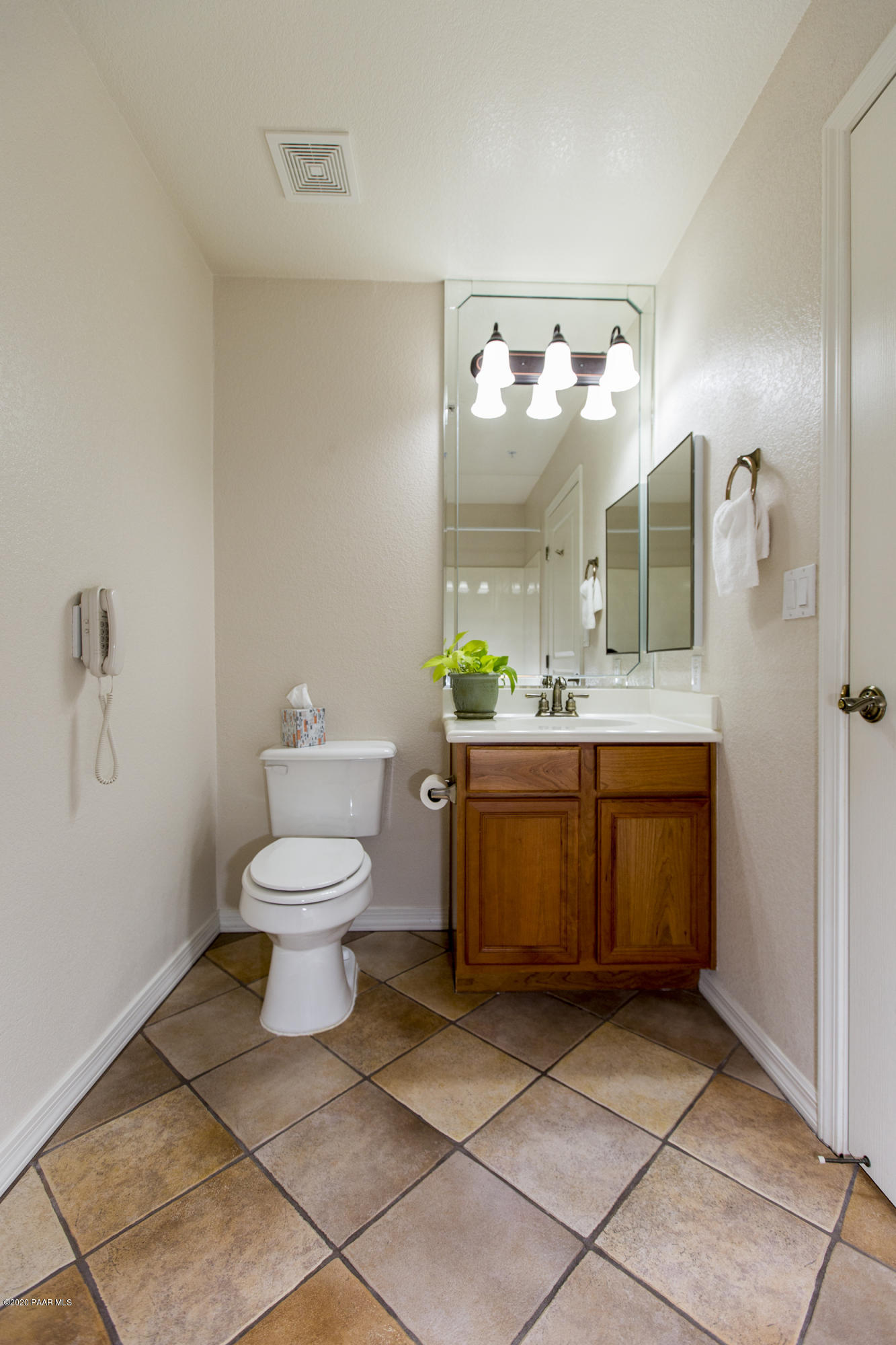 1716 Alpine Meadows Lane, Unit 403 Prescott, AZ 86303 - Photo 24 of 39 a bathroom with a sink a toilet and a mirror