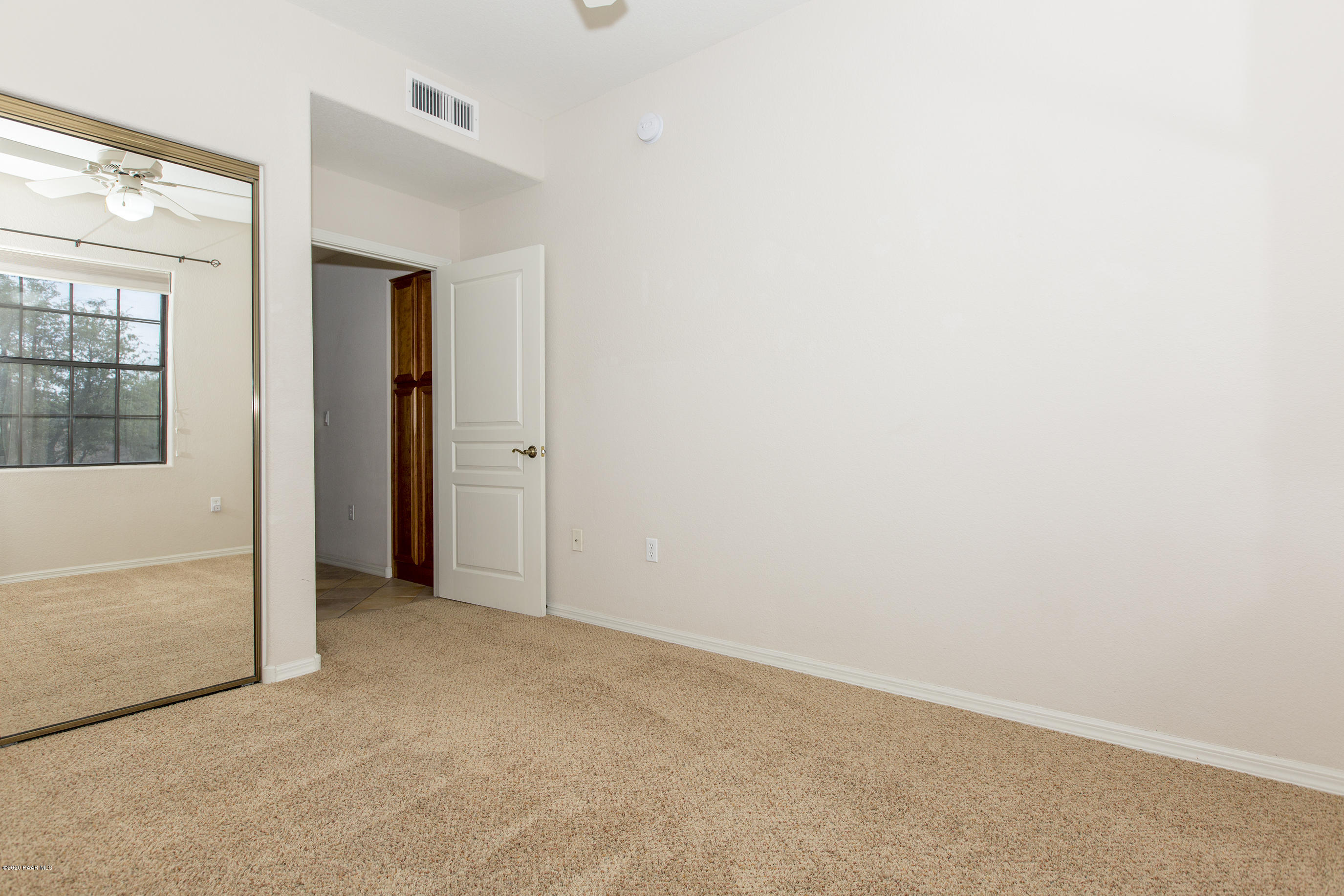1716 Alpine Meadows Lane, Unit 403 Prescott, AZ 86303 - Photo 27 of 39 an empty room with windows and closet