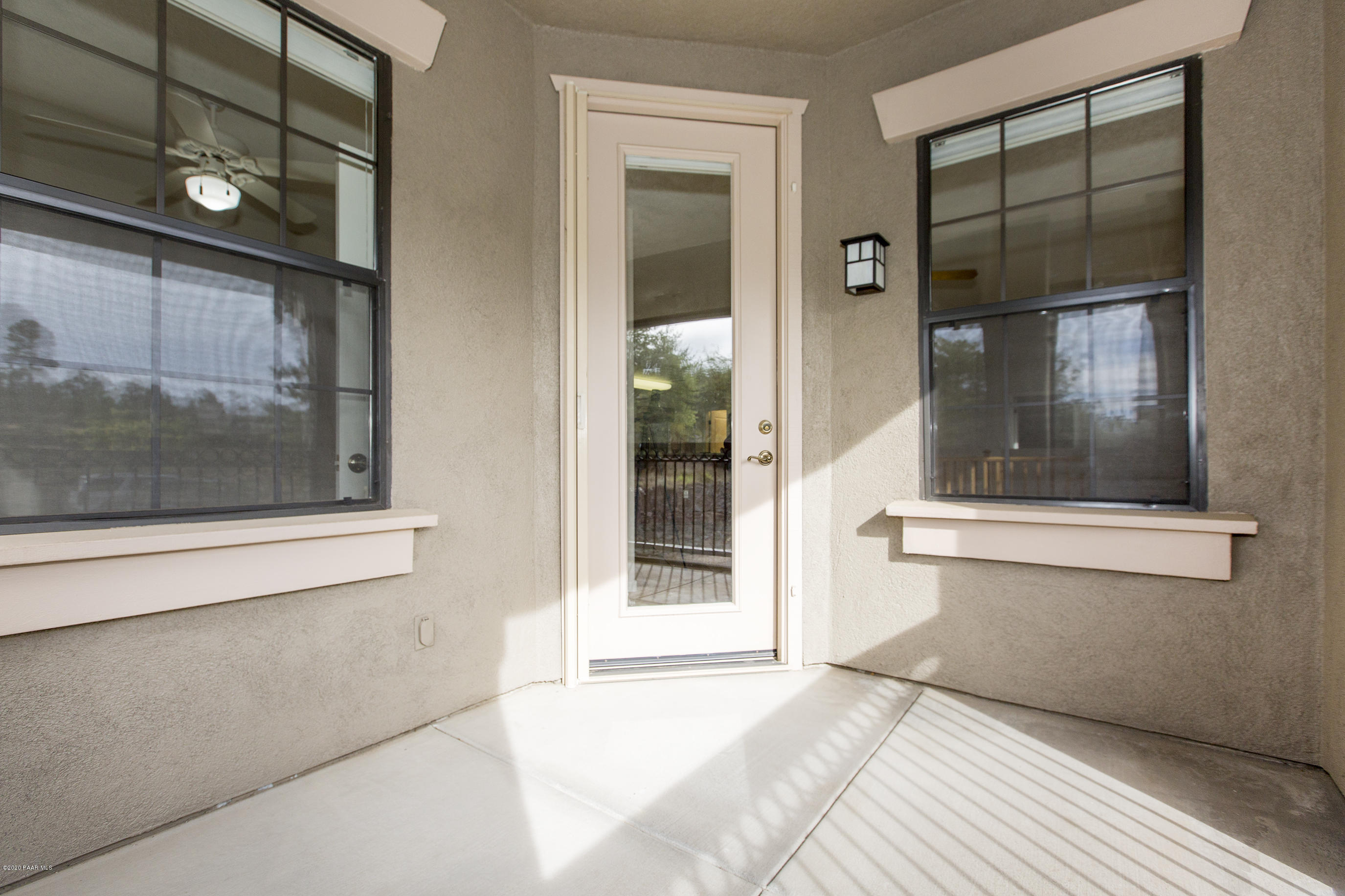 1716 Alpine Meadows Lane, Unit 403 Prescott, AZ 86303 - Photo 28 of 39 a view of a hallway with a glass door and a window