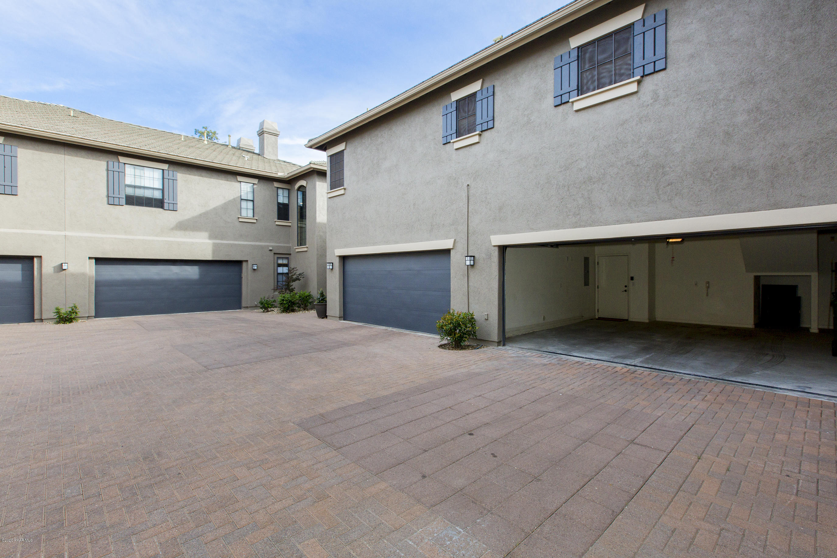 1716 Alpine Meadows Lane, Unit 403 Prescott, AZ 86303 - Photo 30 of 39 a front view of a house with a yard and garage