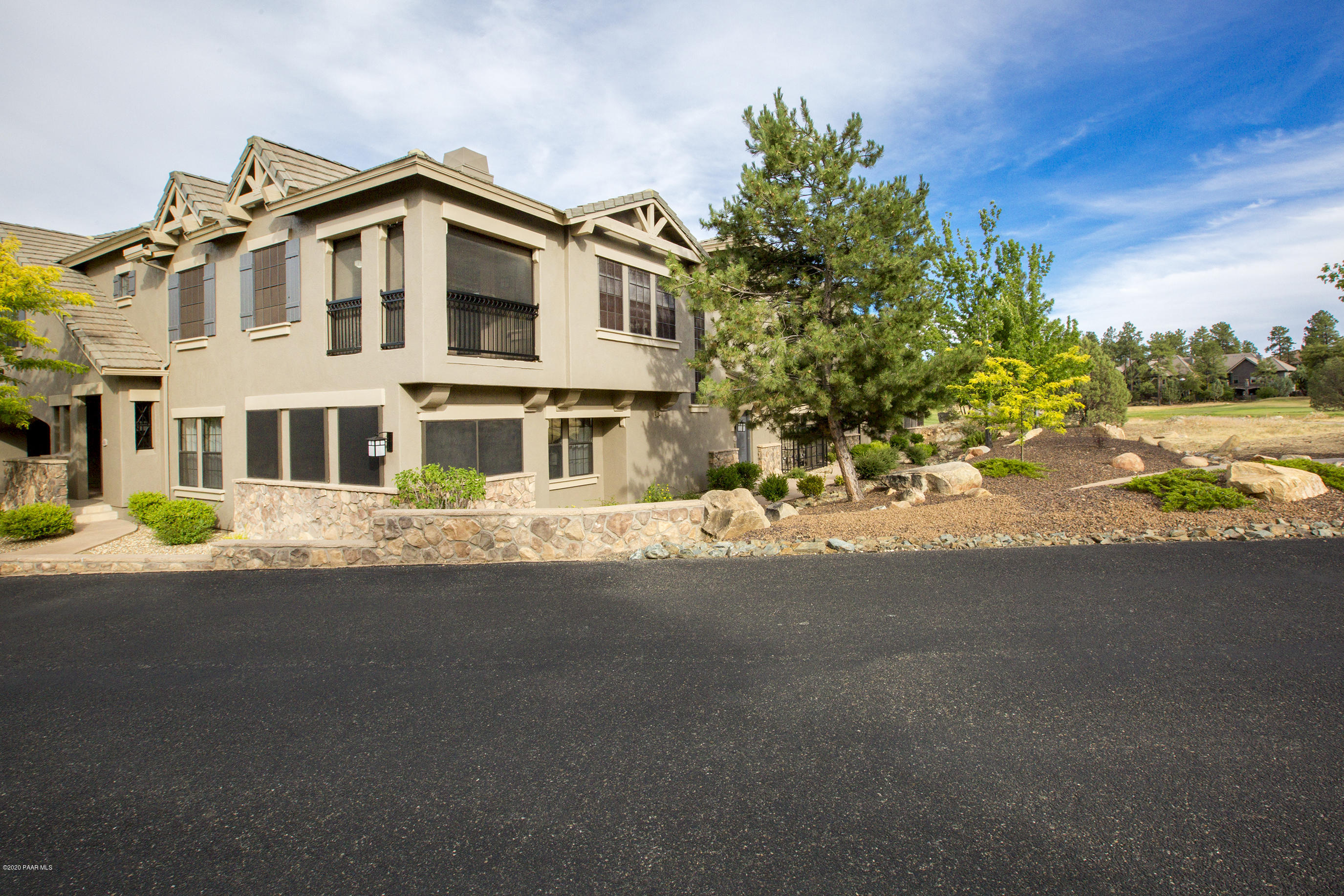 1716 Alpine Meadows Lane, Unit 403 Prescott, AZ 86303 - Photo 3 of 39 a front view of a house with a yard