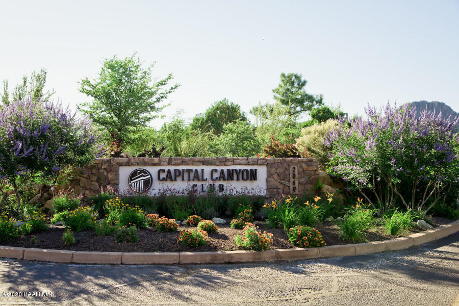 1716 Alpine Meadows Lane, Unit 403 Prescott, AZ 86303 - Photo 34 of 39 a view of a sign board with flower plants in front of main door