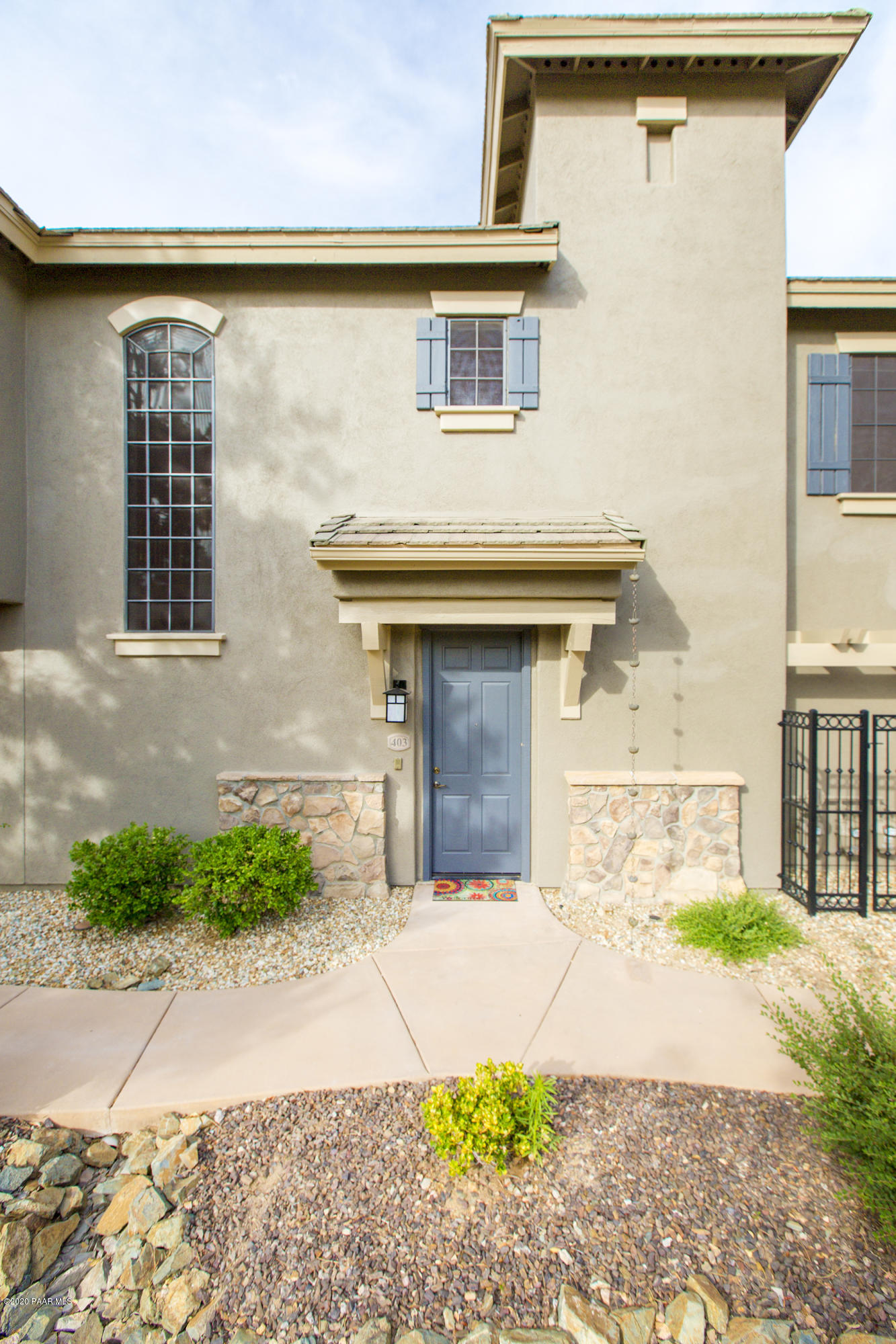 1716 Alpine Meadows Lane, Unit 403 Prescott, AZ 86303 - Photo 4 of 39 a front view of a house with a yard and garage