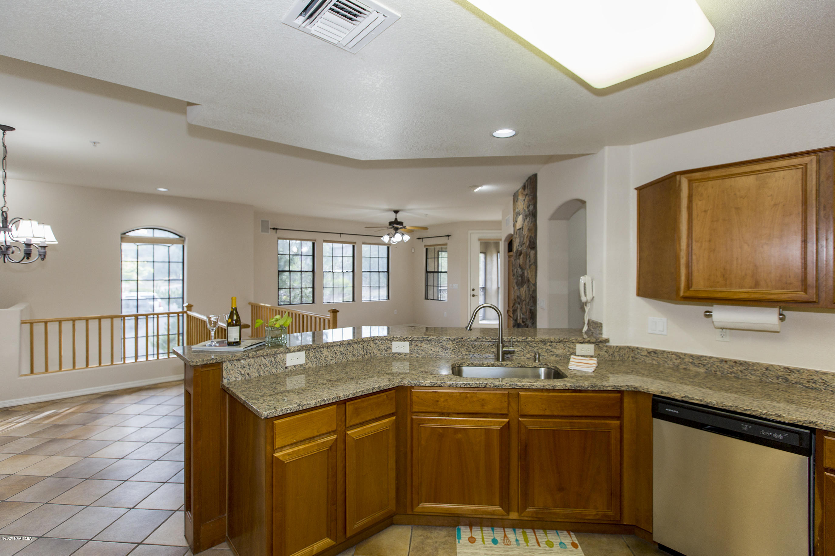 1716 Alpine Meadows Lane, Unit 403 Prescott, AZ 86303 - Photo 10 of 39 a bathroom with granite countertop a sink and a large mirror
