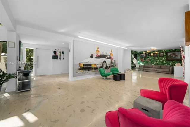 a living room with stainless steel appliances kitchen island granite countertop furniture and a view of living room