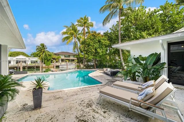 a bed room with furniture and a potted plant