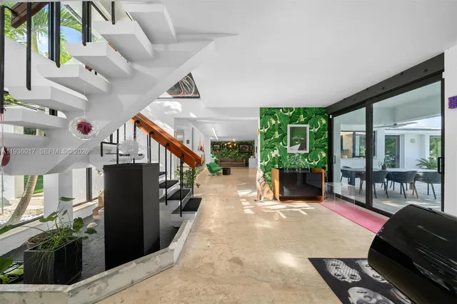 a large bedroom with a bed and glass wall