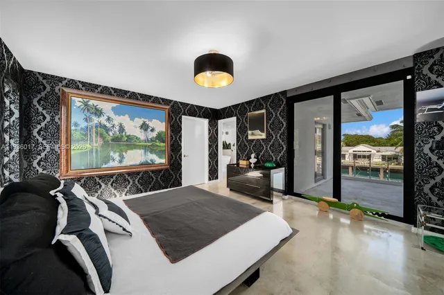 an aerial view of residential houses with outdoor space and river