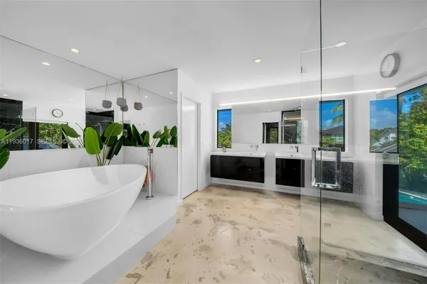 a large bathroom with a tub and shower