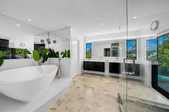 a view of a house with a tree and plants