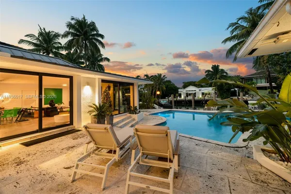 a view of a house with backyard porch and furniture
