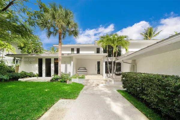 a front view of a house with a garden