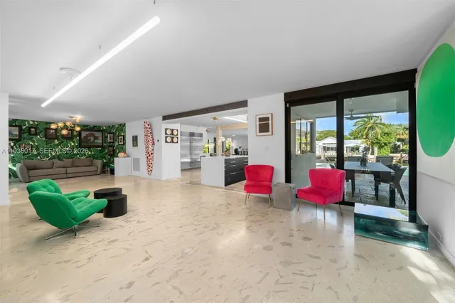 a living room with furniture kitchen view and a window
