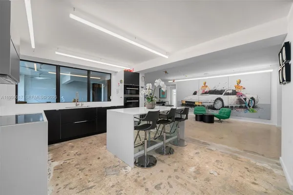 a kitchen with kitchen island a counter top space and cabinets