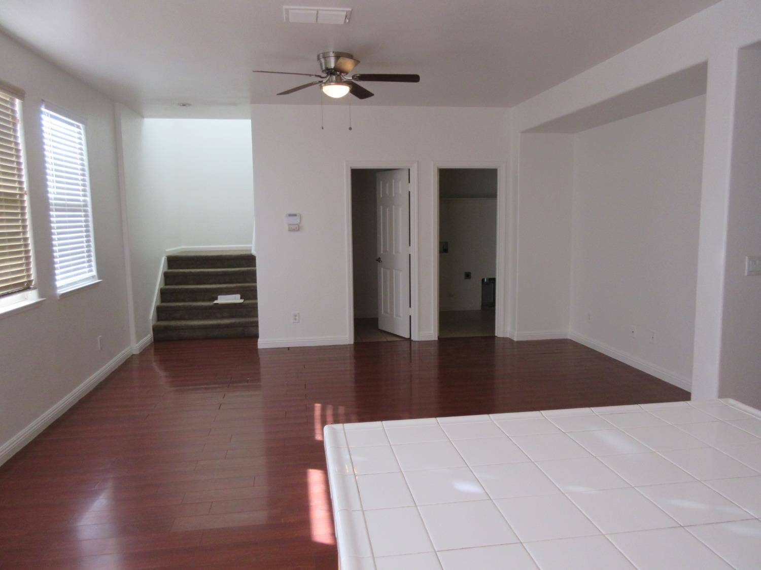 1016 Papaya Street Madera, CA 93638 - Photo 12 of 29 a view of an empty room with wooden floor and a window