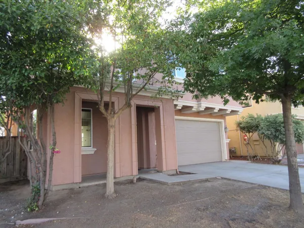 front view of a house with a tree