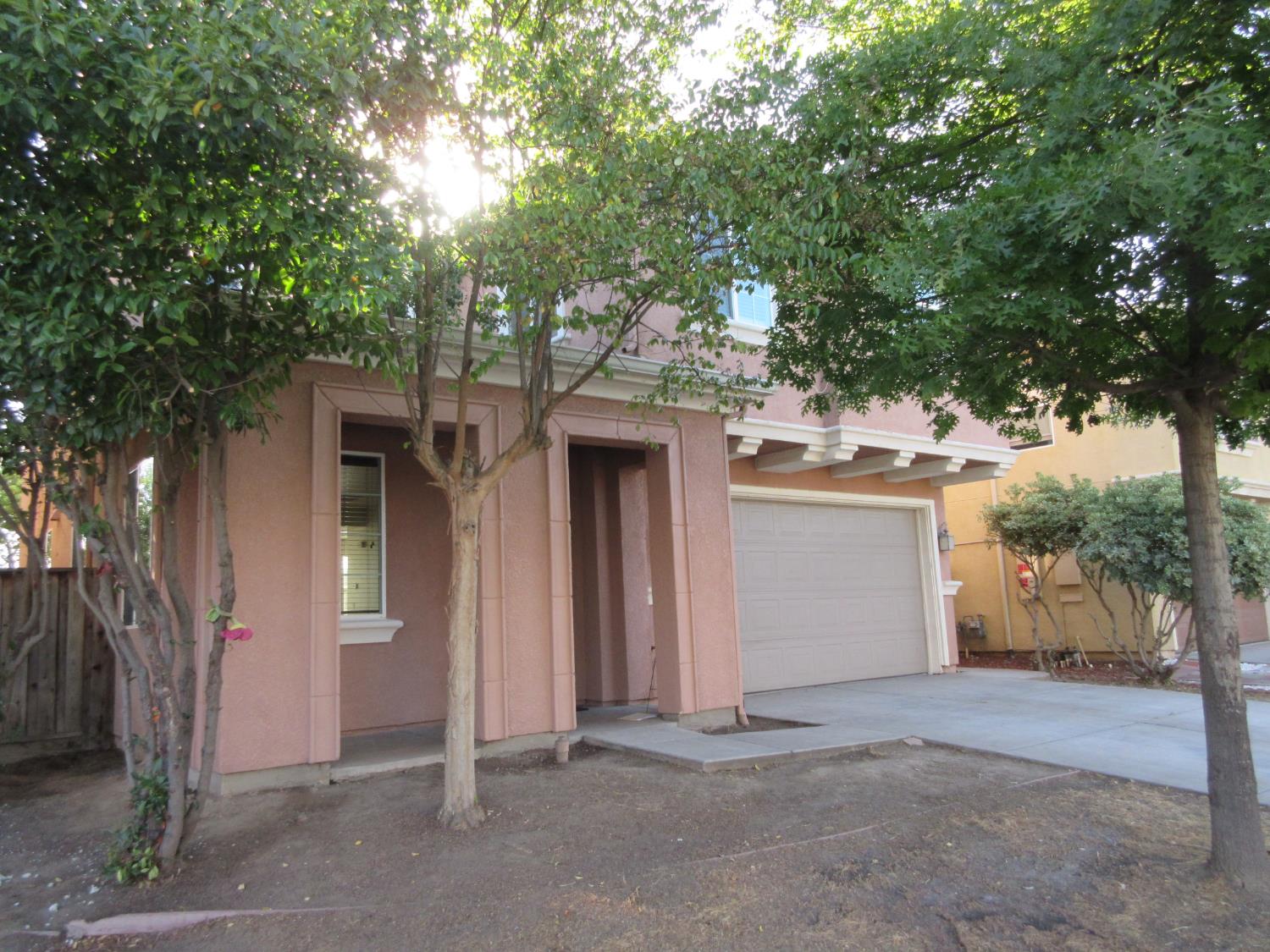 1016 Papaya Street Madera, CA 93638 - Photo 2 of 29 front view of a house with a tree