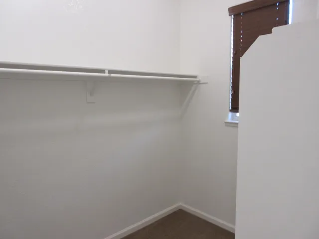 a view of an empty room with empty shelves