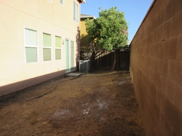 a view of a house with a backyard