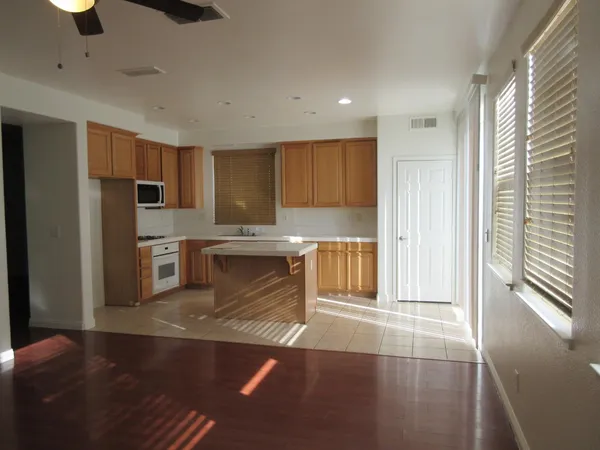 a kitchen with granite countertop a refrigerator and a sink