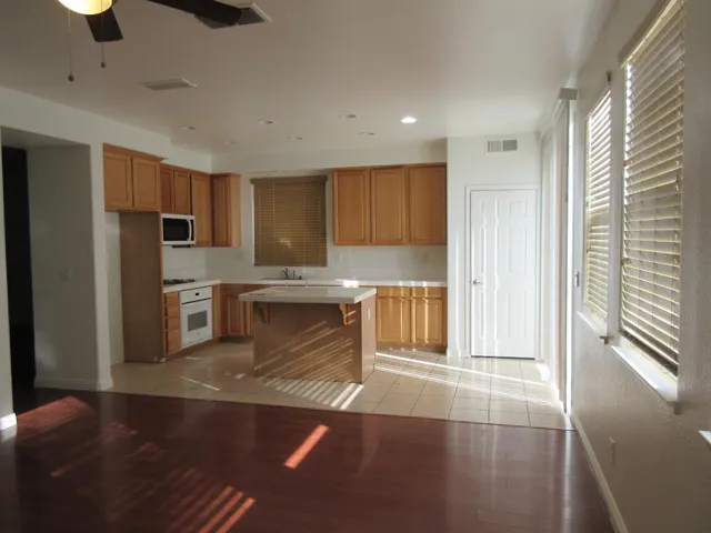 a kitchen with granite countertop a refrigerator and a sink