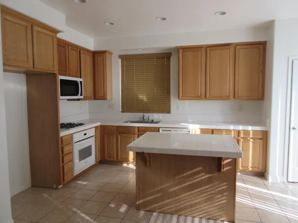 a kitchen with stainless steel appliances granite countertop a sink stove and microwave