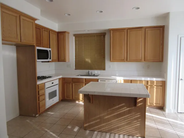 a kitchen with stainless steel appliances granite countertop a sink stove and microwave