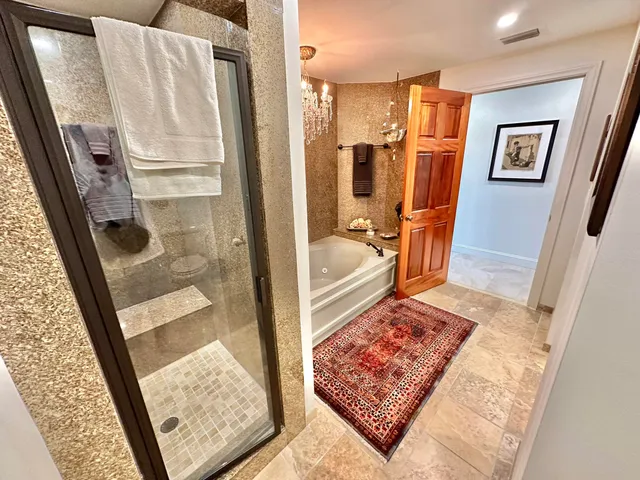 a bathroom with a sink and mirror with toilet