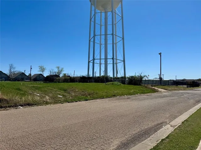 a view of a house with a yard and potted plants