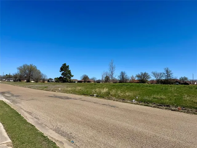 a view of yard with swimming pool and trees