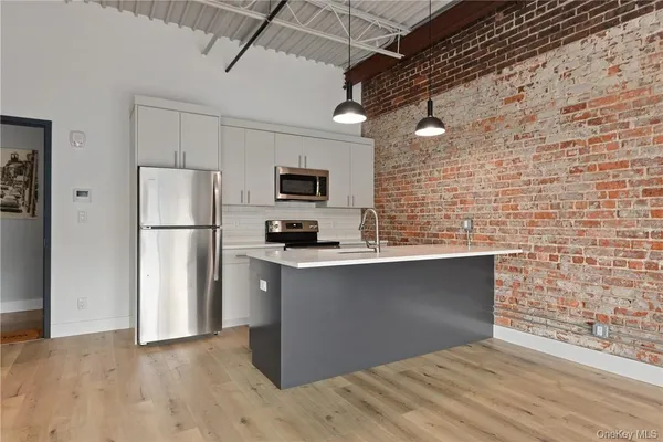 a kitchen with stainless steel appliances a refrigerator and a stove top oven