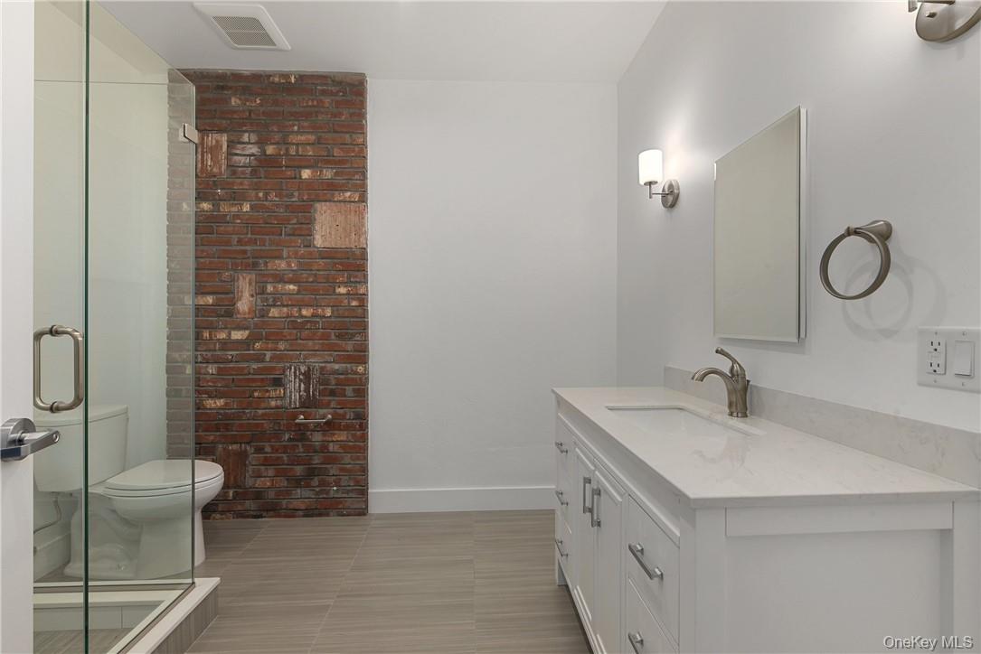 189 North Main Street, Unit 2 Port Chester, NY 10573 - Photo 10 of 13 a bathroom with a double vanity sink toilet and shower