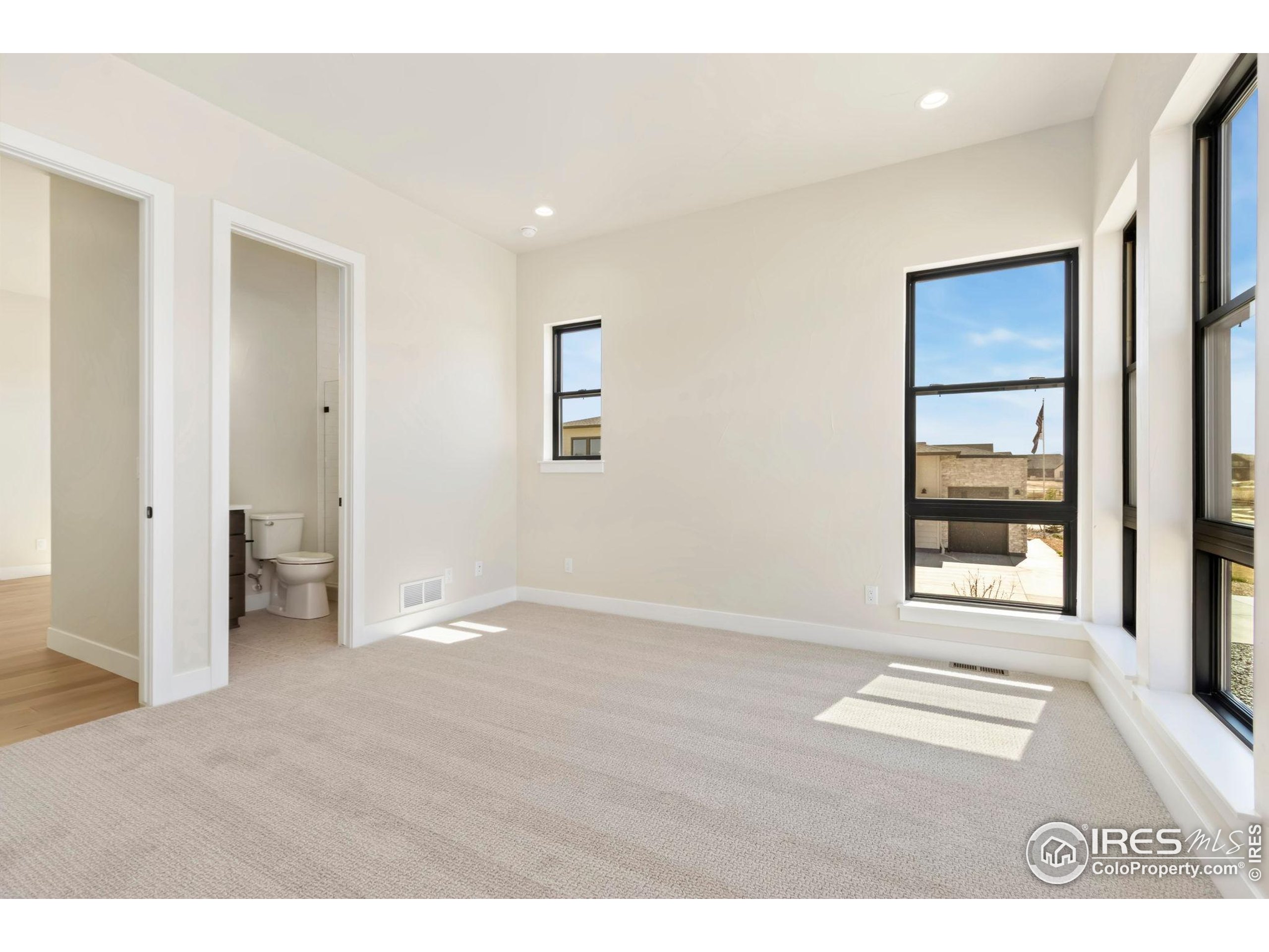 1889 Spring Bloom Drive Windsor, CO 80550 - Photo 11 of 32 an empty room with windows and closet