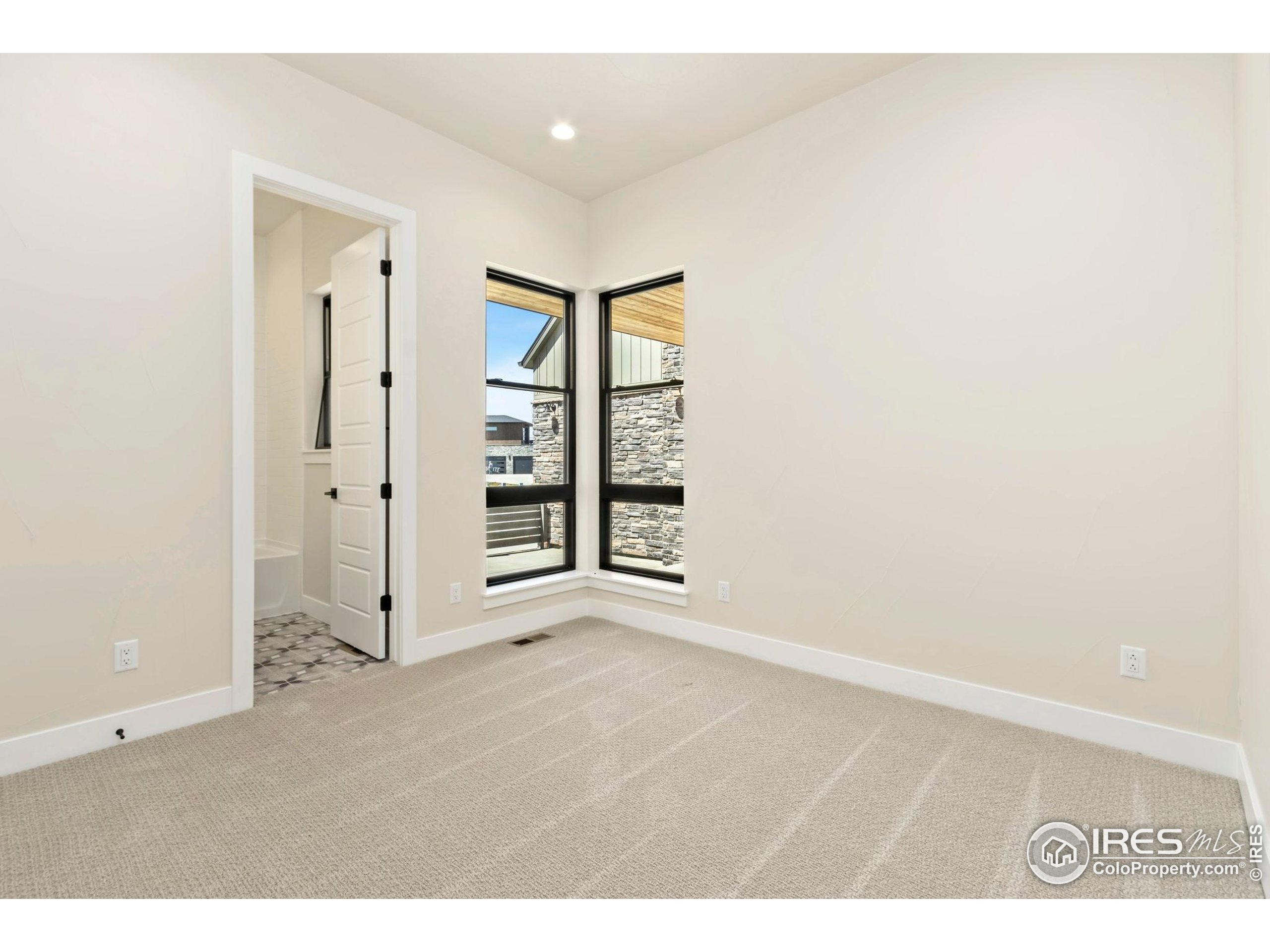 1889 Spring Bloom Drive Windsor, CO 80550 - Photo 13 of 32 an empty room with windows and closet