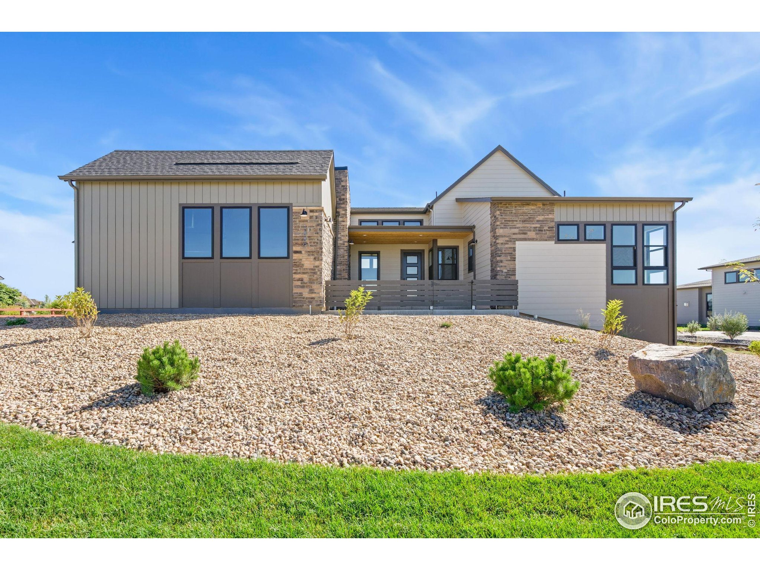 1889 Spring Bloom Drive Windsor, CO 80550 - Photo 19 of 32 a front view of a house with a yard