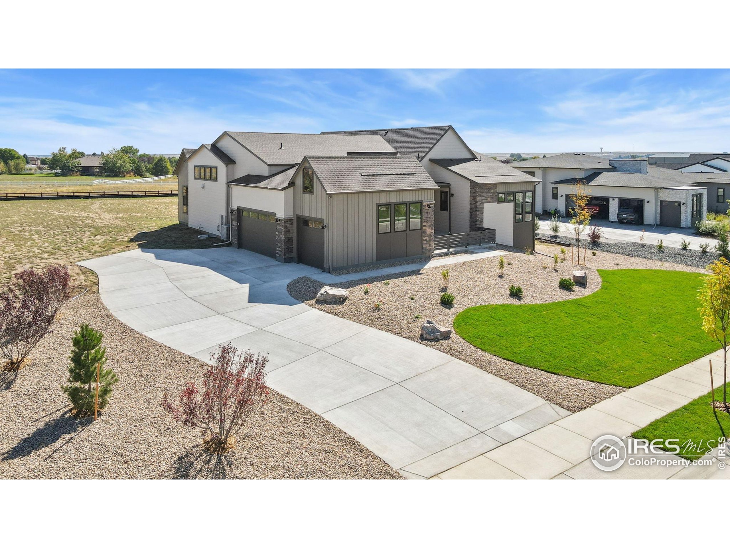 1889 Spring Bloom Drive Windsor, CO 80550 - Photo 2 of 32 a picture of a house with a garden and deck
