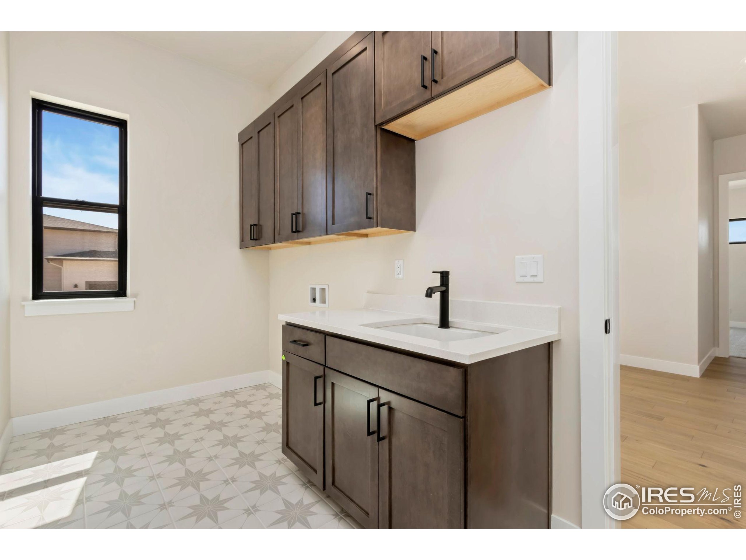 1889 Spring Bloom Drive Windsor, CO 80550 - Photo 9 of 32 a kitchen with a sink and cabinets