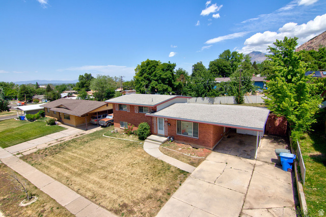 1272 Cook Street Ogden, UT 84404 - Photo 33 of 46 Brick exterior residence featuring a front yard, a paved driveway, and a covered carport