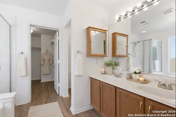 a bathroom with a tub a sink and glass door