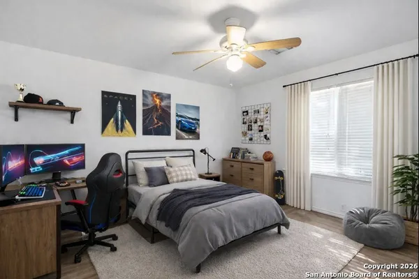 an empty room with a window and a fan