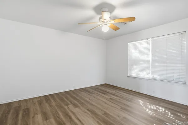 a bathroom with a sink mirror vanity and toilet