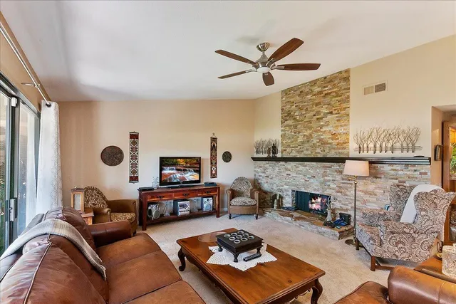 a living room with furniture fireplace and a flat screen tv