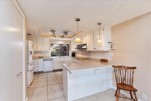 a kitchen with a sink appliances and cabinets
