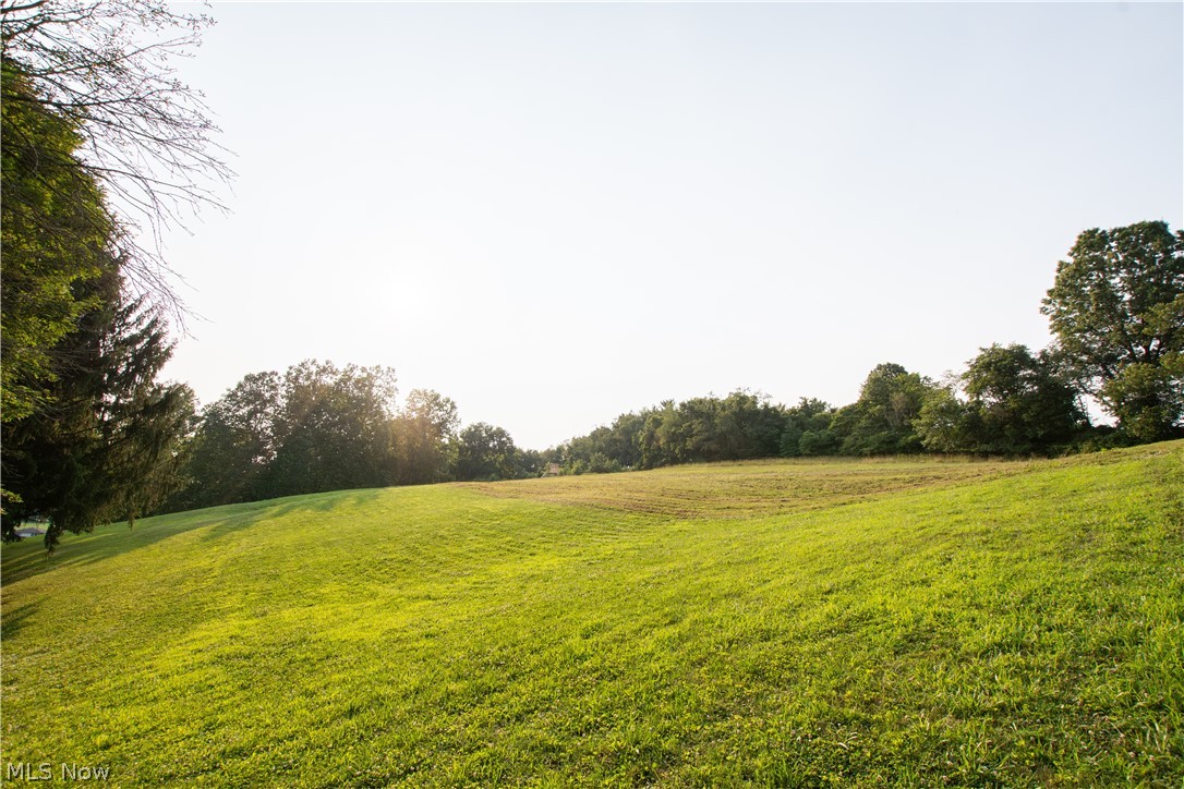 1757 Pleasant Valley Road Northeast New Philadelphia, OH 44663 - Photo 2 of 33 Expansive green lawn with a gentle slope